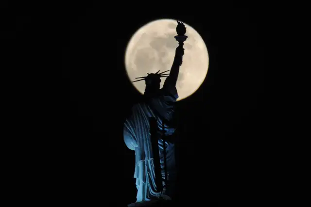 Don't be fooled: THIS IS NOT FROM NY! The full moon rises behind a Statue of Liberty replica atop of a hotel in Kosovo's capital Pristina.